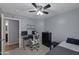 Bedroom featuring a ceiling fan, desk with computer and a view to a bathroom at 8524 S 49Th Ln, Laveen, AZ 85339
