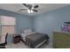 Comfortable bedroom with a ceiling fan and view to a painting on the wall at 8524 S 49Th Ln, Laveen, AZ 85339