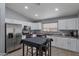 Modern kitchen with stainless steel appliances, white cabinets, and ample counter space at 8524 S 49Th Ln, Laveen, AZ 85339
