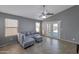 Comfortable living room with ample natural light, a ceiling fan, and access to the backyard at 8524 S 49Th Ln, Laveen, AZ 85339