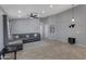 Bright living room with a sectional sofa, ceiling fan, and tiled floors at 8524 S 49Th Ln, Laveen, AZ 85339