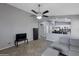 Bright living room with tile floors, gray walls, and an open concept design to the kitchen at 8524 S 49Th Ln, Laveen, AZ 85339