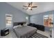 Serene main bedroom featuring light blue walls, tiled floors, and a ceiling fan at 8524 S 49Th Ln, Laveen, AZ 85339