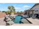 Beautiful pool area with rock waterfall feature, palm trees, and an outdoor dining area at 8524 S 49Th Ln, Laveen, AZ 85339