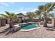 Backyard oasis with a freeform pool, tropical landscaping, and patio furniture at 8524 S 49Th Ln, Laveen, AZ 85339