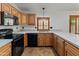 Well-appointed kitchen featuring ample counter space, stainless steel sink, and black appliances at 9852 W Salter Dr, Peoria, AZ 85382
