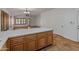 Modern kitchen island with quartz countertop opens to spacious living area at 9852 W Salter Dr, Peoria, AZ 85382