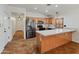 Bright and spacious kitchen with a large island, stainless steel fridge, and ample storage at 9852 W Salter Dr, Peoria, AZ 85382