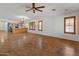Spacious living room with tile floors, ceiling fan, and ample natural light at 9852 W Salter Dr, Peoria, AZ 85382