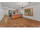 Open-concept floorplan with tile flooring connecting the living and kitchen areas at 9852 W Salter Dr, Peoria, AZ 85382