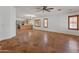 Bright and airy living room with tile floors, chandelier, and an open floor plan to the kitchen at 9852 W Salter Dr, Peoria, AZ 85382