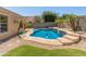 Beautiful backyard pool with dolphin mosaic surrounded by palm trees and manicured landscaping at 9852 W Salter Dr, Peoria, AZ 85382