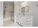 Bright bathroom with walk-in shower, white cabinets, brushed gold hardware and lighting at 10934 E La Verna Way, Scottsdale, AZ 85262