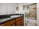 Bathroom featuring a sleek countertop, modern fixtures, and a tiled shower at 10934 E La Verna Way, Scottsdale, AZ 85262