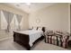 Comfortable bedroom features a wooden bed frame, neutral walls, and a cozy seating area at 10934 E La Verna Way, Scottsdale, AZ 85262
