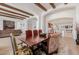 Open-concept dining room with wood beams and views into the living room and kitchen at 10934 E La Verna Way, Scottsdale, AZ 85262