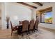 Elegant dining room boasting wood beams, large window, and comfortable seating for six at 10934 E La Verna Way, Scottsdale, AZ 85262