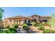 Beautiful home with desert landscaping, stone accents, and a tiled roof under clear skies at 10934 E La Verna Way, Scottsdale, AZ 85262