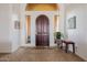 Inviting foyer with a dark wood door, tile flooring, and decorative accents at 10934 E La Verna Way, Scottsdale, AZ 85262