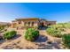 Beautiful home with desert landscaping, stone accents, and a tiled roof at 10934 E La Verna Way, Scottsdale, AZ 85262