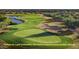 Scenic golf course view featuring lush green fairways, sand traps, a pristine pond and mature trees at 10934 E La Verna Way, Scottsdale, AZ 85262