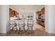 Spacious kitchen with bar seating, dark wood cabinets, and stainless steel appliances at 10934 E La Verna Way, Scottsdale, AZ 85262