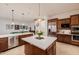 Modern kitchen with dark wood cabinetry, a center island, and open access to the living area at 10934 E La Verna Way, Scottsdale, AZ 85262