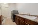 Functional laundry room with updated appliances and countertop at 10934 E La Verna Way, Scottsdale, AZ 85262