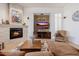 Cozy living room with stone fireplace, comfortable seating, and modern entertainment setup at 10934 E La Verna Way, Scottsdale, AZ 85262