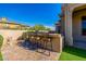 Outdoor bar with four barstools and a tiled backsplash, perfect for entertaining friends at 10934 E La Verna Way, Scottsdale, AZ 85262