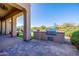 Built-in grill on an outdoor patio with a view of the backyard and swimming pool at 10934 E La Verna Way, Scottsdale, AZ 85262