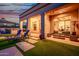 Spacious covered patio with lounge area, outdoor dining, and lush backyard landscaping at 10934 E La Verna Way, Scottsdale, AZ 85262