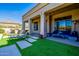 Covered patio with an outdoor living space and lush artificial grass at 10934 E La Verna Way, Scottsdale, AZ 85262