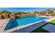 Private pool area with a stone waterfall feature, desert landscaping, and a wrought iron fence at 10934 E La Verna Way, Scottsdale, AZ 85262