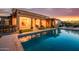 Luxury home featuring a backyard pool, an outdoor lounge area, and covered patio at 10934 E La Verna Way, Scottsdale, AZ 85262