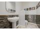 Tastefully decorated powder room with pedestal sink, beautiful tile accents, and lighting at 10934 E La Verna Way, Scottsdale, AZ 85262
