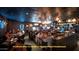 Upscale restaurant interior with dim lighting, booths, tables, decorative lamps, and a lively bar at 10934 E La Verna Way, Scottsdale, AZ 85262