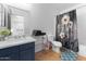 Well-lit bathroom with a stylish vanity, mirror, and decorative shower curtain at 10939 W Meadowbrook Ave, Phoenix, AZ 85037
