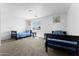 Bedroom has two beds, neutral carpeting and plain white walls at 10939 W Meadowbrook Ave, Phoenix, AZ 85037