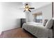 Well-lit bedroom features a ceiling fan, large window, and neutral tones, creating a peaceful retreat at 10939 W Meadowbrook Ave, Phoenix, AZ 85037