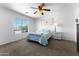Serene bedroom features a carpet, ceiling fan, and natural light, creating a calming and comfortable atmosphere at 10939 W Meadowbrook Ave, Phoenix, AZ 85037