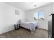 Bedroom features a neutral walls, carpet, and window at 10939 W Meadowbrook Ave, Phoenix, AZ 85037