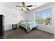 Bedroom features a ceiling fan, window, neutral walls, and carpet at 10939 W Meadowbrook Ave, Phoenix, AZ 85037