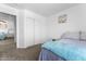 Bedroom features large closet and view into the hall at 10939 W Meadowbrook Ave, Phoenix, AZ 85037