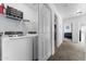 Laundry area in the hallway with modern washer and dryer appliances at 10939 W Meadowbrook Ave, Phoenix, AZ 85037