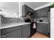 Kitchen area boasting stone countertops and cabinets with modern appliances at 10939 W Meadowbrook Ave, Phoenix, AZ 85037