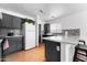 Well-lit kitchen featuring stone countertops, stainless steel appliances, and gray cabinets at 10939 W Meadowbrook Ave, Phoenix, AZ 85037