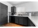 Kitchen area with stone countertops and gray cabinets with modern appliances at 10939 W Meadowbrook Ave, Phoenix, AZ 85037