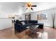 Living room showcasing a large sofa, tile flooring, and an open-concept layout at 10939 W Meadowbrook Ave, Phoenix, AZ 85037