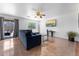Living room area with tile floors, ceiling fan, sofa, and sliding glass doors at 10939 W Meadowbrook Ave, Phoenix, AZ 85037